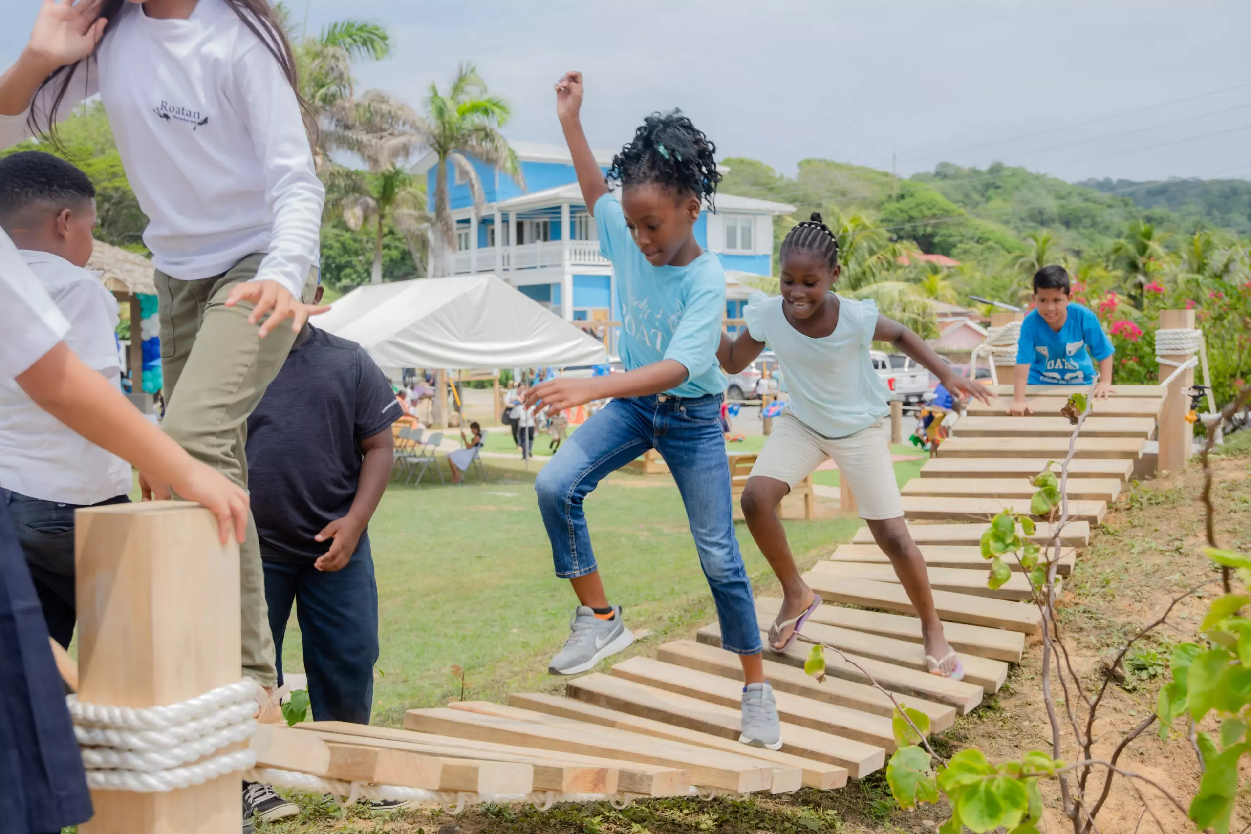 Boys on seesaw at park in Roatan, Honduras